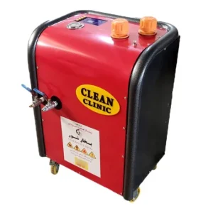 A red and black machine labeled 'CLEAN CLINIC' with two orange knobs on the top, a gauge, and a blue-handled valve on the side. The machine is mounted on four wheels for mobility and has a white label with text in another language and warning symbols on the front. It appears to be cleaning or sanitizing equipment, possibly a steam cleaner, given the label 'CLEAN CLINIC' and the presence of the valve