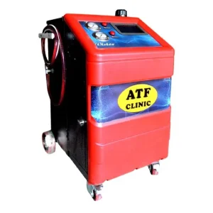 A blue machine labeled 'Victor ATF Clinic' with a digital display and several buttons for operation. The machine is equipped with hoses and nozzles for dispensing Automatic Transmission Fluid (ATF). It is mounted on a mobile cart with wheels for easy movement in a workshop setting