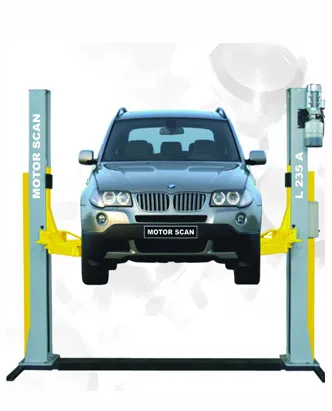 A two-post car lift labeled 'MOTOR SCAN' and 'L 235 A,' lifting a BMW SUV off the ground. The yellow arms of the lift securely hold the vehicle in place, allowing easy access to the underside for maintenance and repair work. This type of equipment is commonly used in automotive repair shop